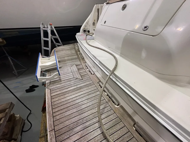 Slide: The Image of 1999 Sea Ray 450 Sundancer yacht with wooden deck in a storage facility. - 4