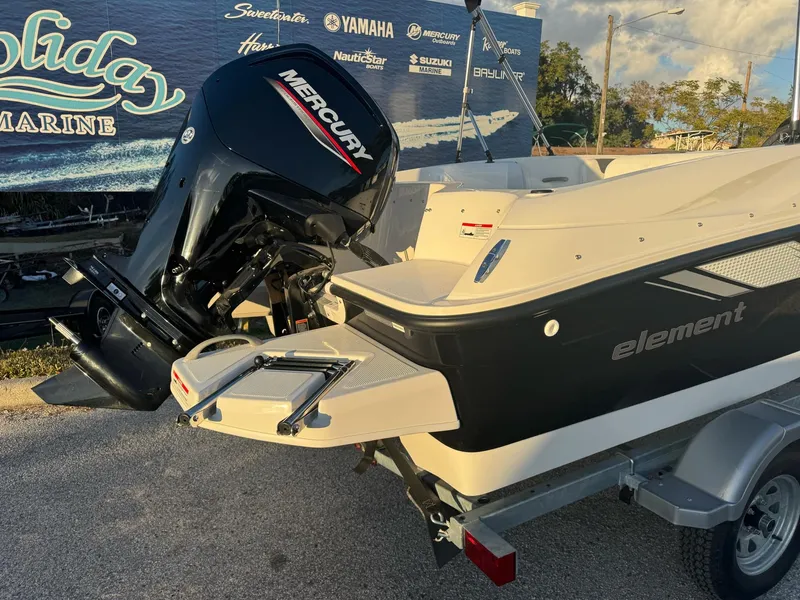 Slide: The Image of 2025 Bayliner Element E16 boat with Mercury outboard motor, displayed outdoors. - 5