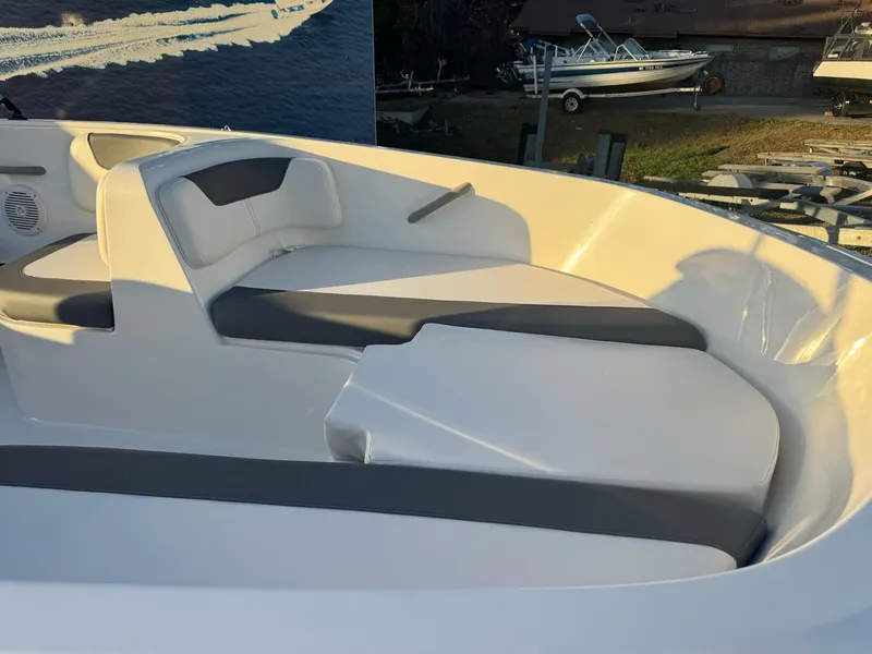 Slide: The Image of 2025 Bayliner Element E16 boat interior with cushioned seating and sleek design. - 6