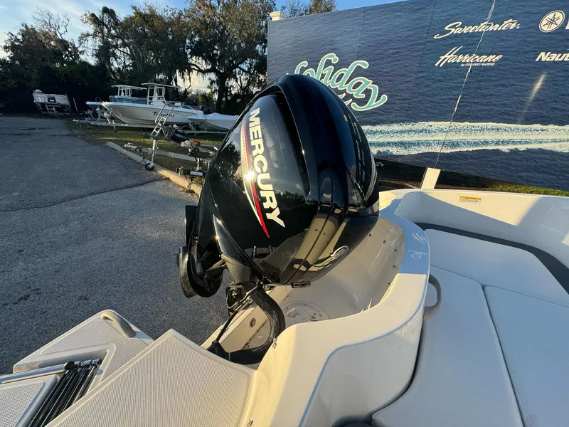 Slide: The Image of 2025 Bayliner Element E16 with Mercury outboard motor in a marina setting. - 9