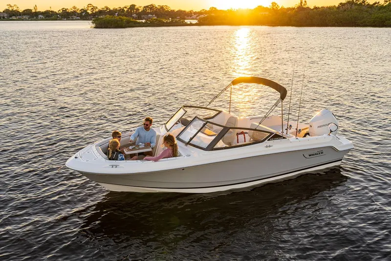 Slide: The Image of 2025 Boston Whaler 210 Vantage boat cruising at sunset with passengers. - 2