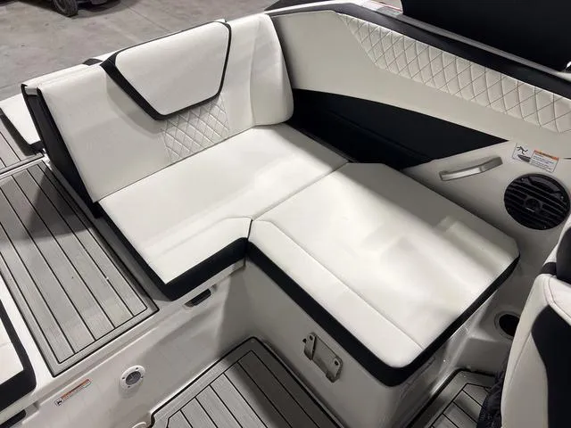 Slide: The Image of 2025 Yamaha Boats 222SD interior seating with white and black upholstery, diamond stitching. - 10