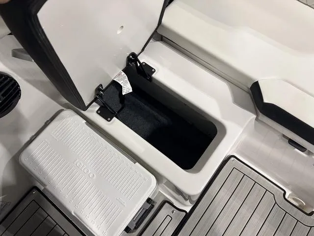 Slide: The Image of 2025 Yamaha Boats 222SD storage compartment and cooler on deck. - 11