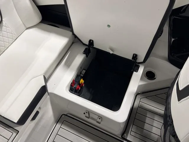Slide: The Image of 2025 Yamaha Boats 222SD storage compartment with open hatch, showcasing interior space. - 12