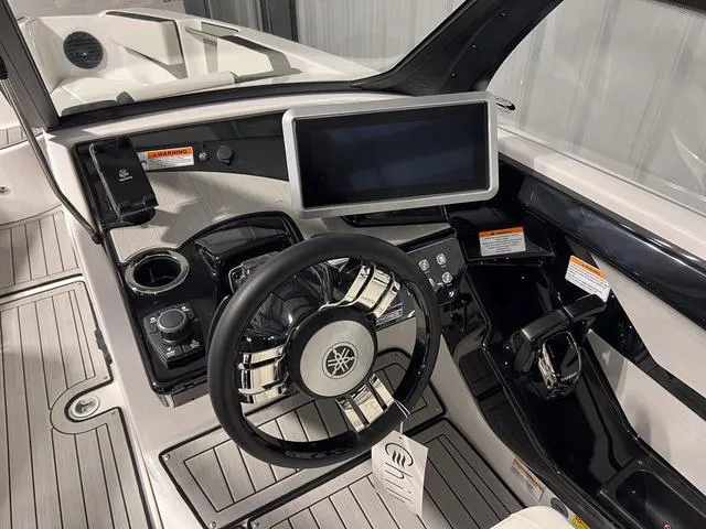 Slide: The Image of 2025 Yamaha Boats 222SD dashboard with modern controls and sleek steering wheel. - 17