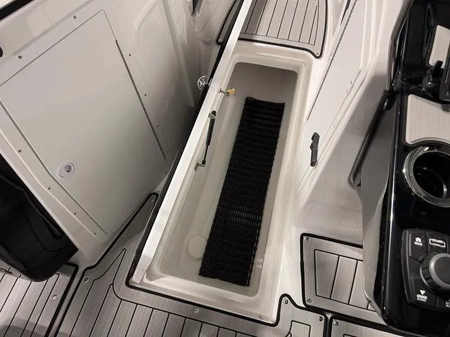 Slide: The Image of 2025 Yamaha Boats 222SD storage compartment with sleek design and modern features. - 24