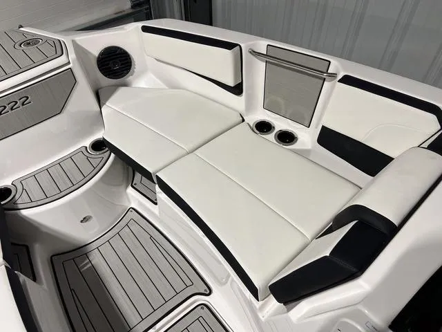 Slide: The Image of 2025 Yamaha Boats 222SD interior with white seating and cup holders. - 26