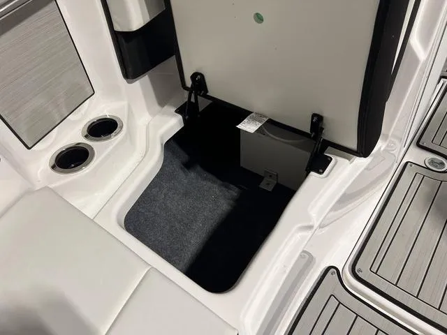 Slide: The Image of 2025 Yamaha Boats 222SD storage compartment with cup holders and sleek interior design. - 28