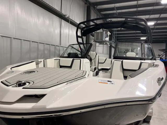 Slide: The Image of 2025 Yamaha Boats 222SD in a showroom, showcasing sleek design and spacious seating. - 4