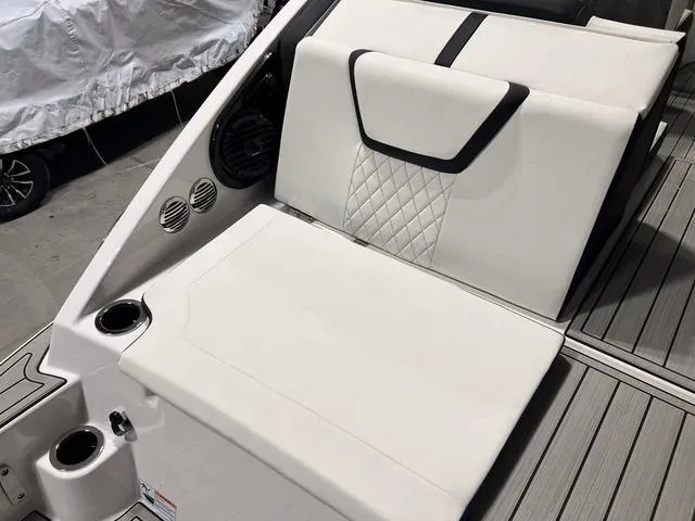 Slide: The Image of 2025 Yamaha Boats 222SD interior seating with cup holders and sleek design. - 7