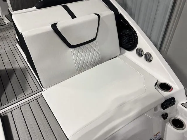 Slide: The Image of 2025 Yamaha Boats 222SD interior seating with cup holder and speaker. - 8
