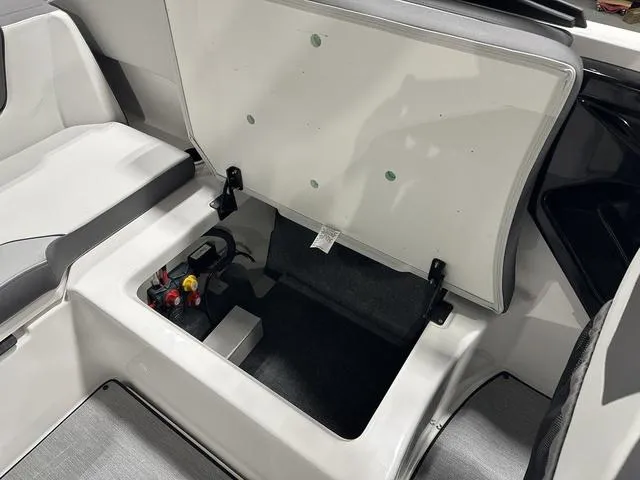Slide: The Image of 2025 Yamaha AR250 boat storage compartment with open lid, showcasing interior space. - 14