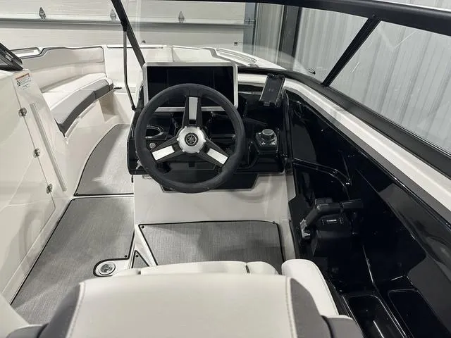 Slide: The Image of 2025 Yamaha AR250 boat interior with steering wheel and seating. - 18
