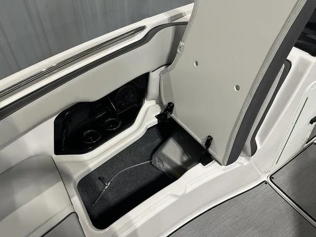 Slide: The Image of 2025 Yamaha AR250 boat storage compartment with open hatch, showcasing interior design. - 24