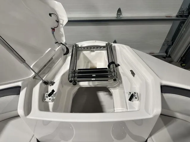 Slide: The Image of 2025 Yamaha AR250 boat with open storage compartment and ladder. - 25