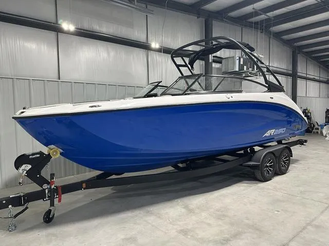 Slide: The Image of 2025 Yamaha Boats AR250 in a showroom, featuring a sleek blue and white design. - 3