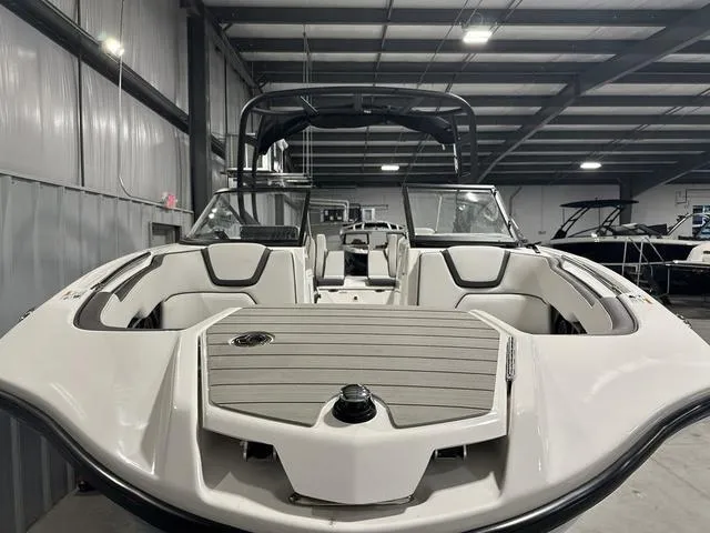 Slide: The Image of 2025 Yamaha Boats AR250 in a showroom, showcasing sleek design and spacious interior. - 4