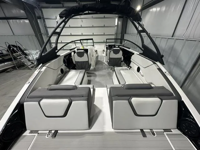 Slide: The Image of 2025 Yamaha Boats AR250 interior, sleek design, spacious seating, modern features, in a showroom setting. - 7
