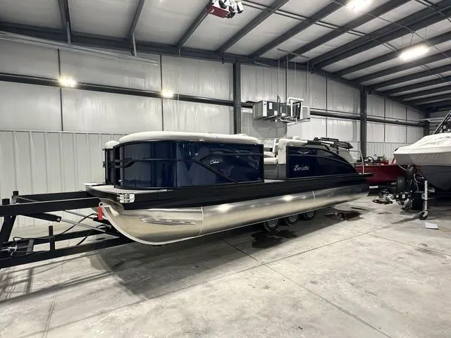 Slide: The Image of 2025 Barletta Cabrio C22M pontoon boat in a spacious indoor storage facility. - 3