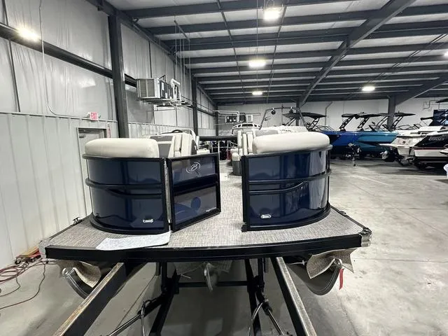 Slide: The Image of 2025 Barletta Cabrio C22M pontoon boat in showroom, featuring sleek design and comfortable seating. - 4