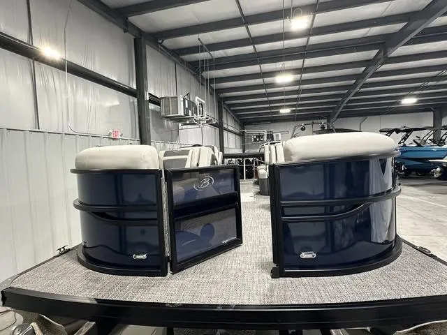 Slide: The Image of 2025 Barletta Cabrio C22M pontoon boat in a spacious indoor showroom. - 5