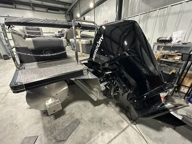 Slide: The Image of 2025 Barletta Cabrio C22M boat with Mercury outboard motor in a garage setting. - 6