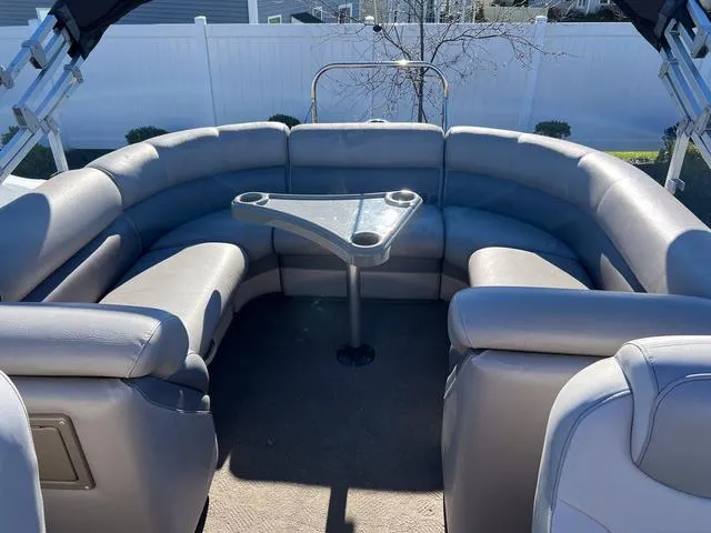 Slide: The Image of Premier Solaris 250 RF 2012 boat interior with curved seating and table. - 21