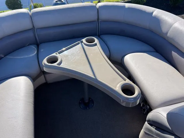 Slide: The Image of Premier Solaris 250 RF 2012 boat interior with curved seating and triangular table. - 22