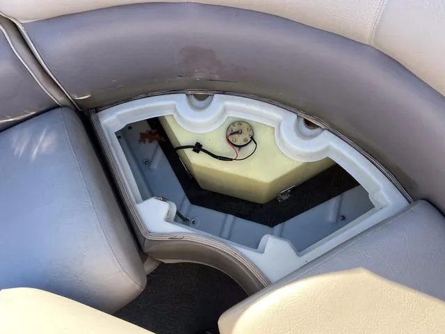 Slide: The Image of Premier Solaris 250 RF 2012 boat seat storage compartment with exposed wiring and tank. - 28