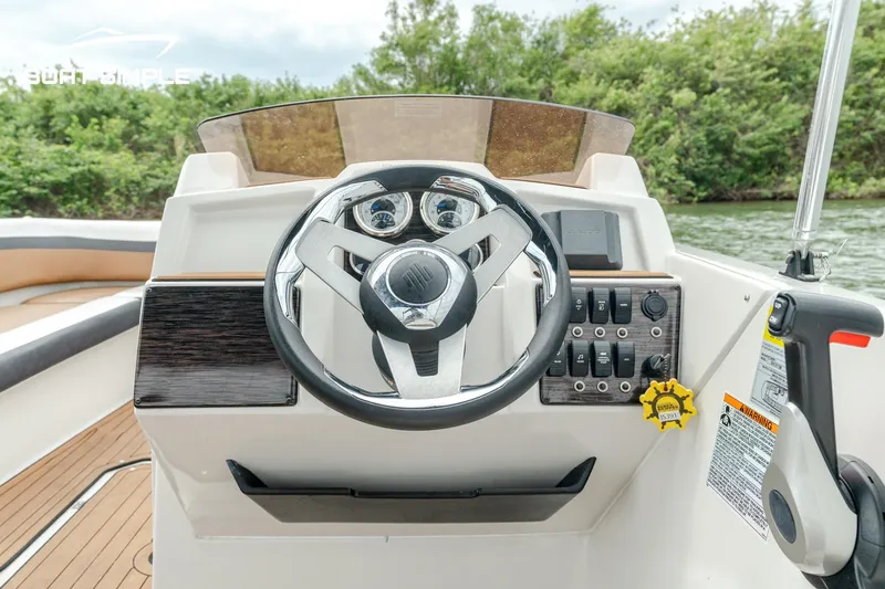 Slide: The Image of 2024 Starcraft SVX 211 OB boat dashboard with steering wheel and control panel. - 5