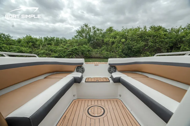 Slide: The Image of 2024 Starcraft SVX 211 OB boat interior with cushioned seating and wood flooring. - 6