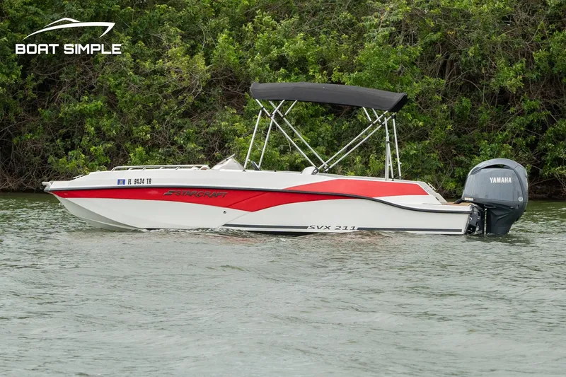 Slide: The Image of 2024 Starcraft SVX 211 OB boat with Yamaha outboard on a calm river. - 0