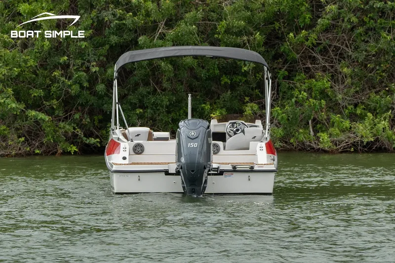 Slide: The Image of 2024 Starcraft SVX 211 OB boat on water, rear view with outboard motor. - 3