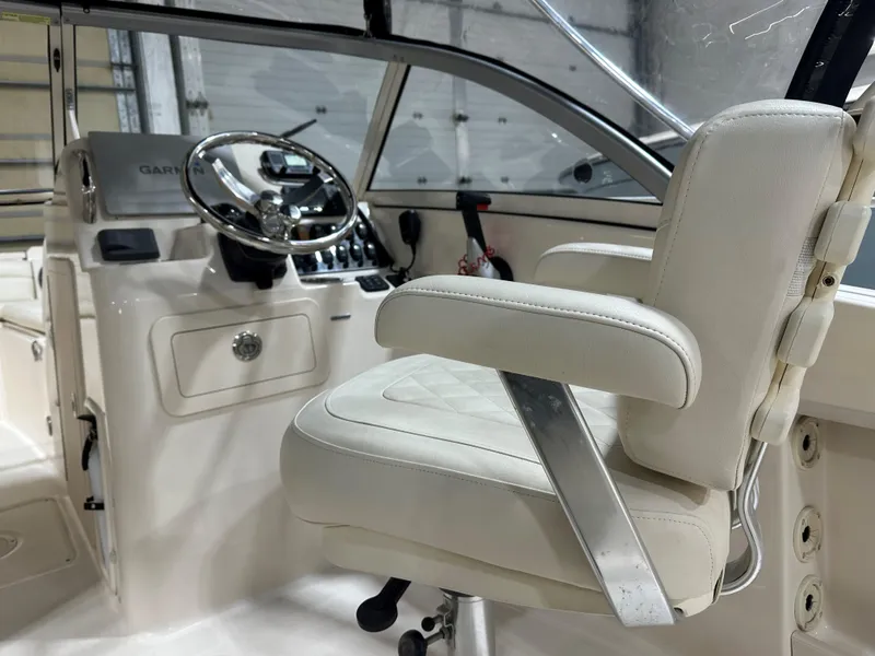 Slide: The Image of 2020 Grady-White 215 Freedom boat interior with steering wheel and captain's chair. - 10