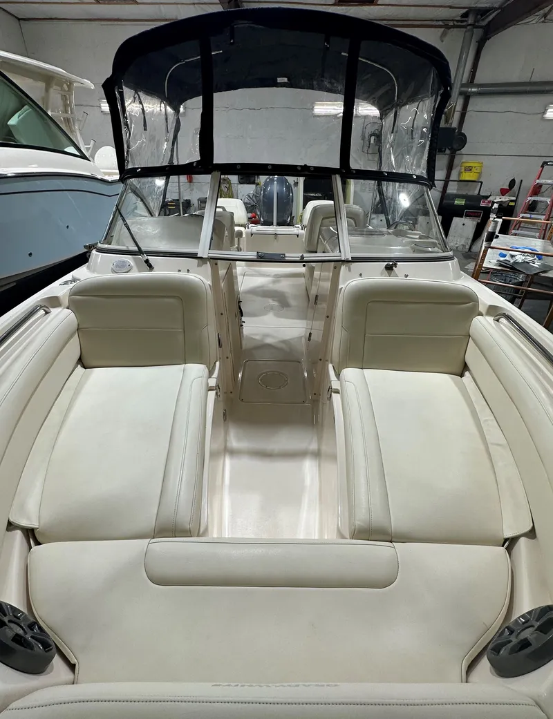 Slide: The Image of 2020 Grady-White 215 Freedom boat interior with beige seating and canopy in a showroom. - 3
