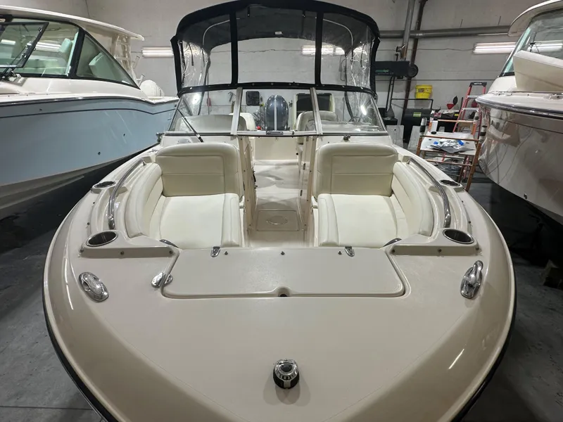 Slide: The Image of 2020 Grady-White 215 Freedom boat with spacious seating and sleek design in a showroom. - 4