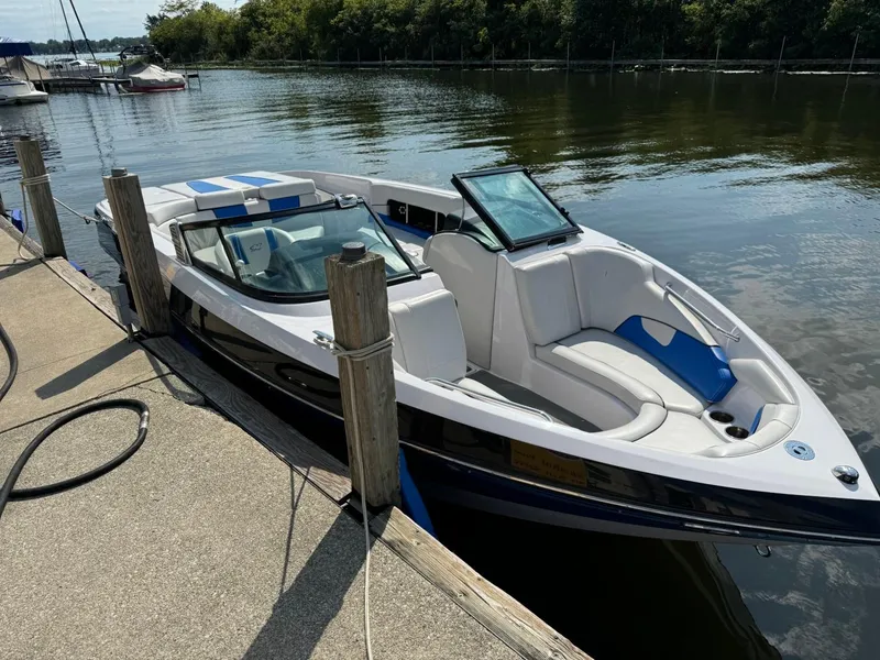 Slide: The Image of 2010 Nautique Sport Nautique 226 boat docked on calm water. - 1