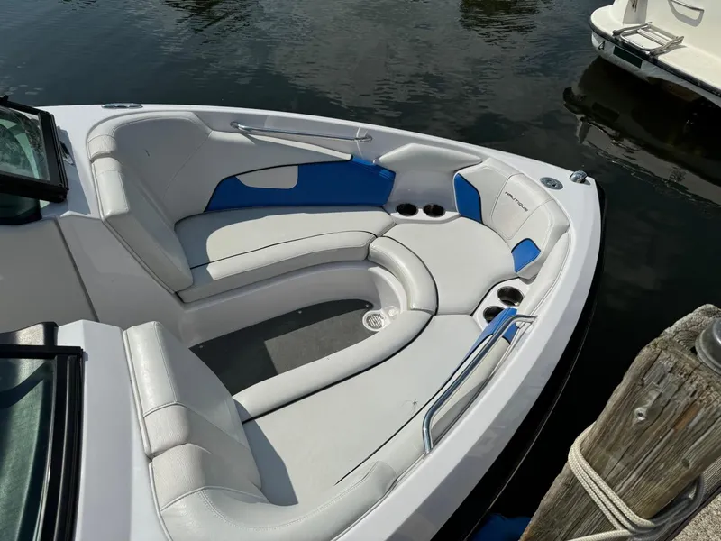 Slide: The Image of 2010 Nautique Sport Nautique 226 boat interior with white and blue seating. - 2