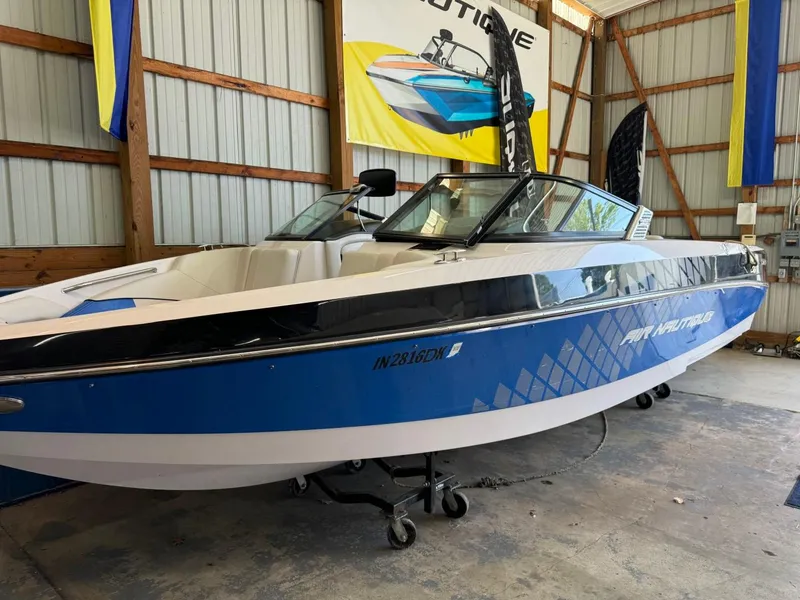 Slide: The Image of 2010 Nautique Sport Nautique 226 boat in a storage facility. - 23
