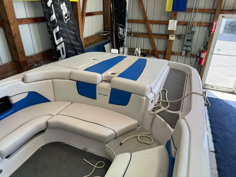 Slide: The Image of 2010 Nautique Sport Nautique 226 boat interior with white and blue seating. - 27