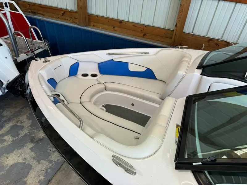 Slide: The Image of 2010 Nautique Sport Nautique 226 boat interior with white and blue seating. - 28