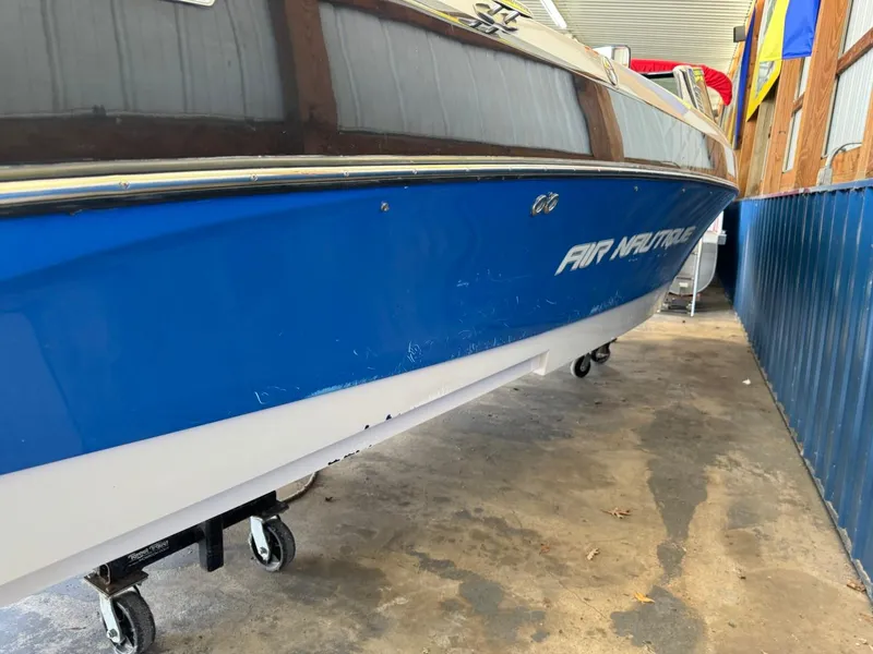 Slide: The Image of 2010 Nautique Sport Nautique 226 boat in storage, blue and white exterior. - 30