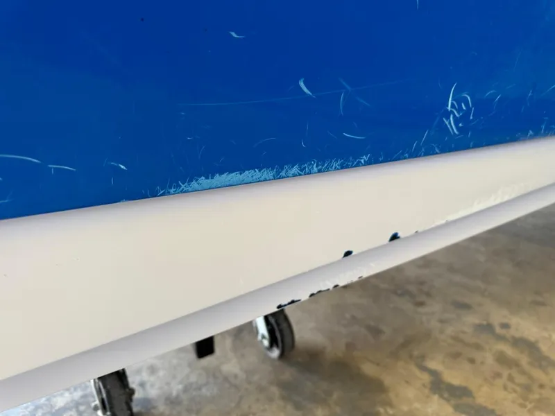 Slide: The Image of Close-up of 2010 Nautique Sport Nautique 226 boat hull with visible scratches. - 31