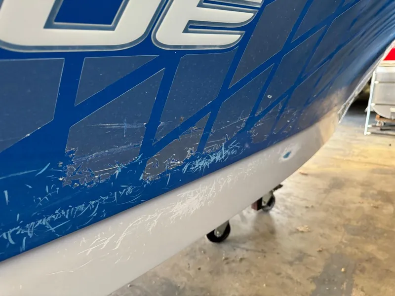 Slide: The Image of 2010 Nautique Sport Nautique 226 with visible hull scratches. - 33