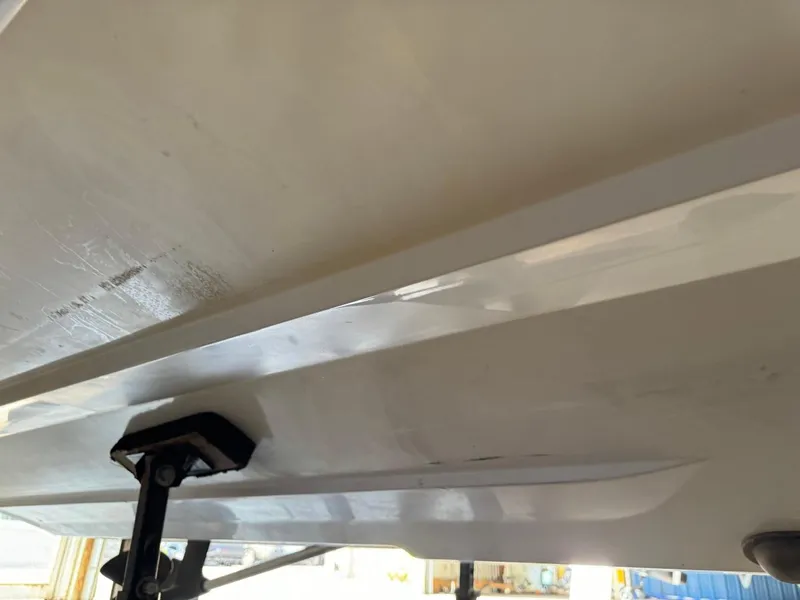 Slide: The Image of 2010 Nautique Sport Nautique 226 boat hull underside, showing clean white surface and support structure. - 34
