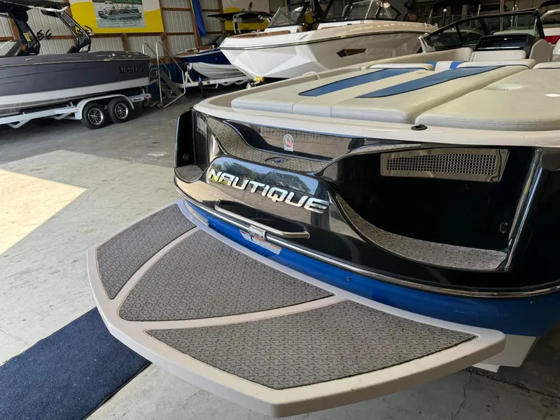 Slide: The Image of 2010 Nautique Sport Nautique 226 boat in showroom, rear view with swim platform. - 36