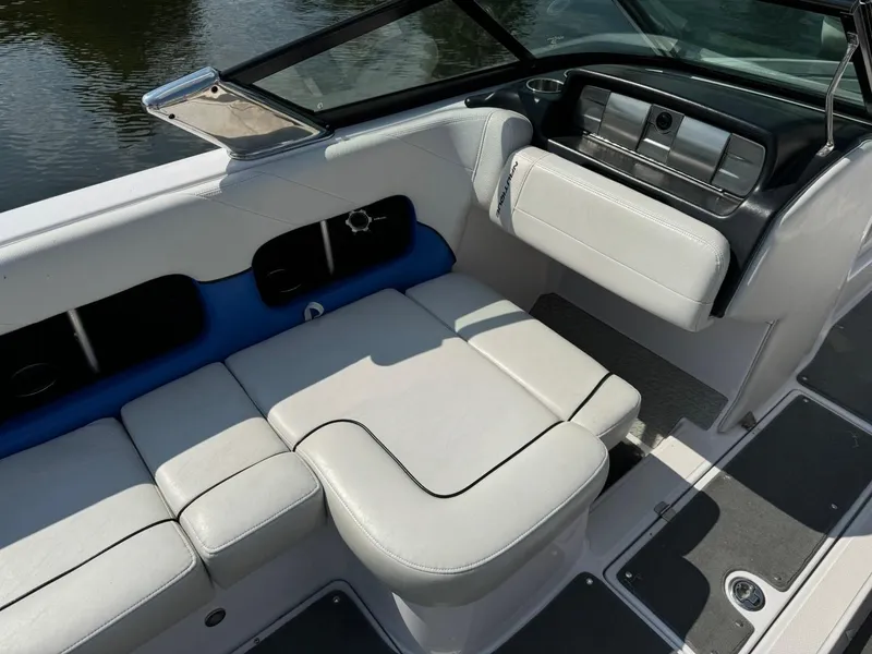 Slide: The Image of 2010 Nautique Sport Nautique 226 boat interior with white seating and sleek design. - 5