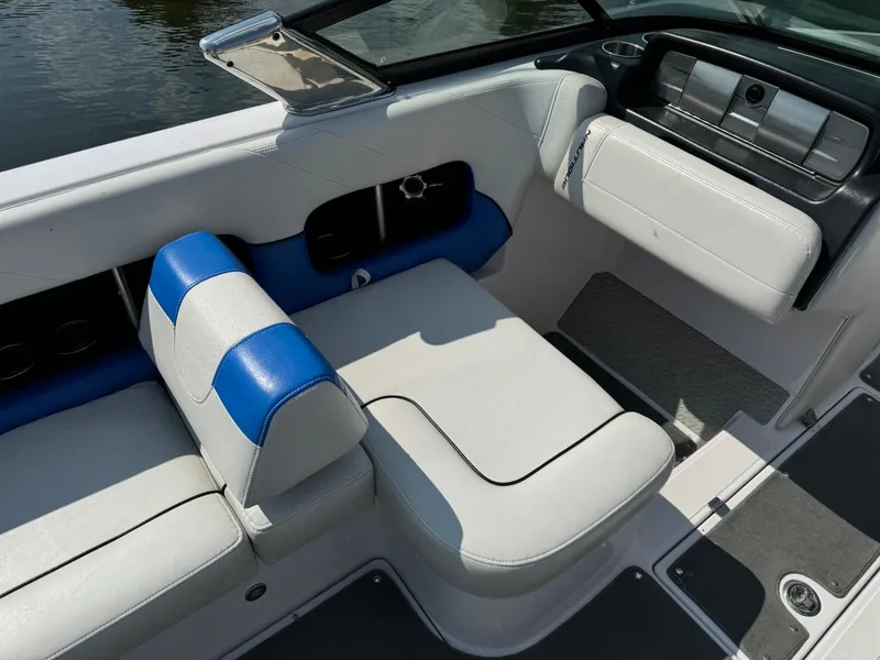 Slide: The Image of 2010 Nautique Sport Nautique 226 boat interior with white and blue seating. - 6