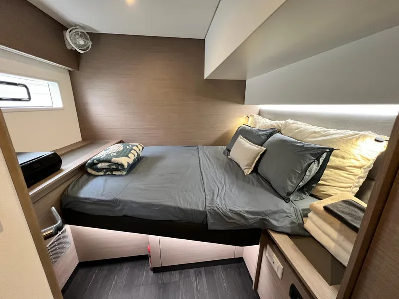 Slide: The Image of 2022 Fountaine Pajot Aura 51 yacht with solar panel, docked near waterfront homes. - 49