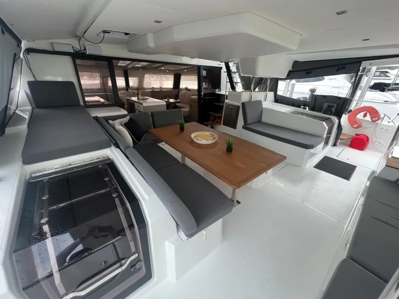Slide: The Image of 2022 Fountaine Pajot Aura 51 catamaran sailing with blue spinnaker on open sea. - 56